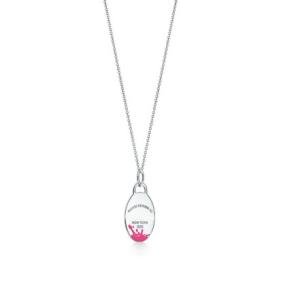 Tiffany silver necklace paired with pink heart-shaped pendant,
